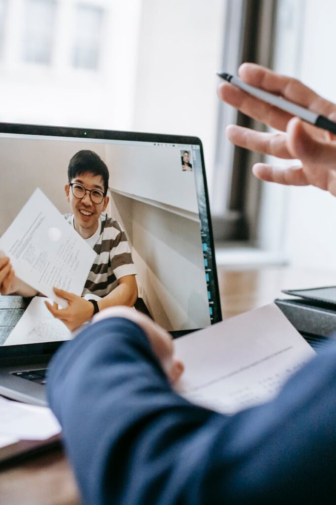 Two professionals engaged in a video conference showing office documents.